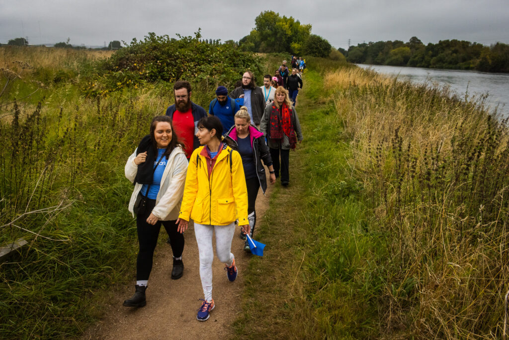 the team walking on a rural path near Beeston as part of a charity walk for Base 51